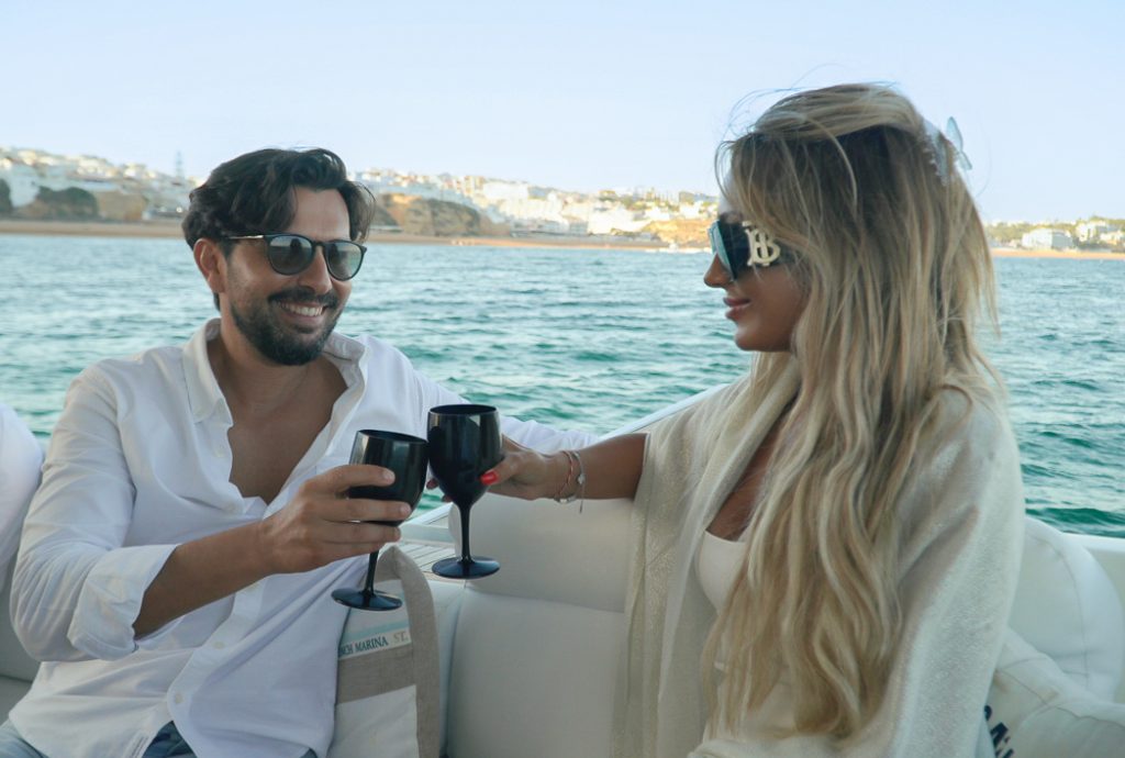 Couple enjoying romantic luxury yacht experience Algarve at sunset
